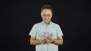 Man distributing banknotes and tossing them into the air. video