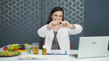 Nutritionist dietitian doctor makes heart on camera. Healthy lifestyle. video