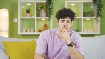 Thoughtful young man doing calculations in his head and coming up with an idea. video