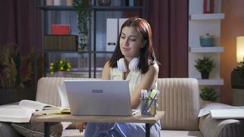 Female student trying to finish her homework at night. video