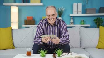 The greedy old man is happy and cheerful at home and loves their money. video