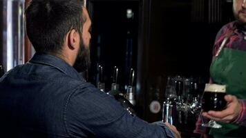 Unrecognizable man drinking delicious craft beer at the pub video