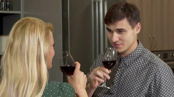 Handsome man clinking glasses with his girlfriend celebrating buying new home video