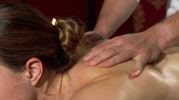 Professional masseur working at spa center massaging back of a beautiful woman video