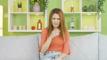 Disgusted by the smell, young woman is holding her nose. video