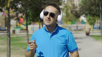 Cheerful man listening to music outdoors. video