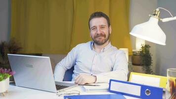 Home office worker man looking emotional at camera. video