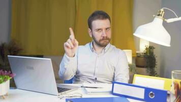 Home office worker man looking at camera with a stern angry warning. video