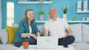 Couple watching comedy movie on laptop. They are having fun. video