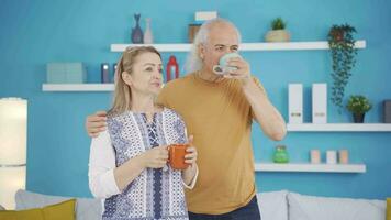 Happy couple enjoying coffee at home. video