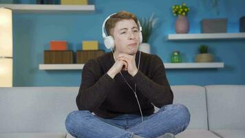 Unhappy teenager is alone at home and listening to music. video