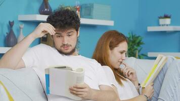 Husband and wife reading a book together. Happy and peaceful couple. video