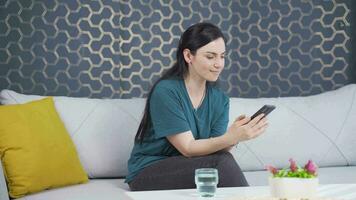 Woman smiling at phone message. video