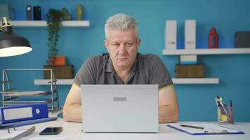 Home office worker man looking dull at camera. video