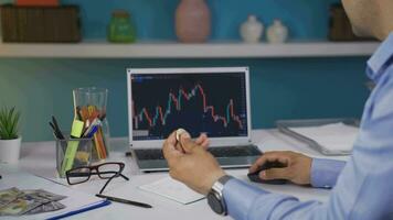 Investor examining cryptocurrency chart. He has bitcoin. video