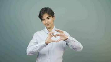 Young woman making heart sign at camera. video