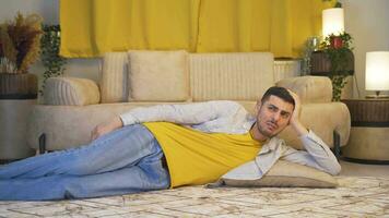 The man lying on the sofa is crying. video