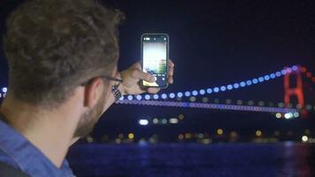 Man walking by the sea and using phone. video