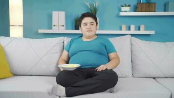 Obesity boy falls asleep while watching tv. video