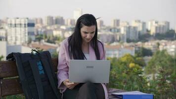 Stressed and nervous Businesswoman working outdoors in the park. video