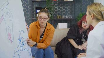 Psychiatrist analyzes her patient who draws pictures. video