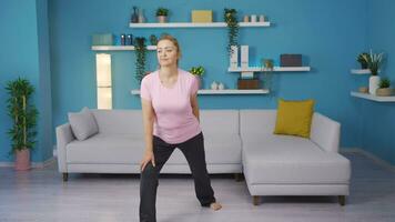 Woman exercising at home. Leg stretching. video