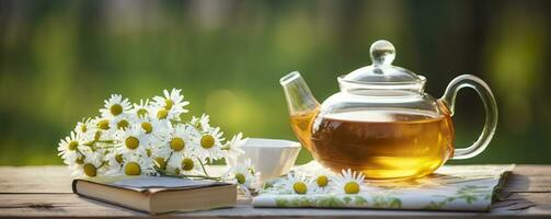 Chamomile flowers, books, a glass teapot, and a cup of herbal tea on a table closeup. Generative AI photo