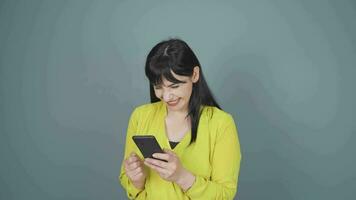 The woman looking at the phone is happy. video