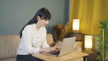 Happy woman using laptop at night. video