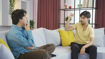 Friends play charades together at home. video