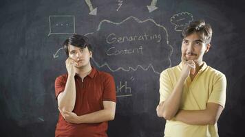 Young man writing Creating Content on the chalkboard. video