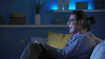 The man who watches a comedy movie with laughter. video