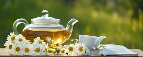 Chamomile flowers, books, a glass teapot, and a cup of herbal tea on a table closeup. Generative AI photo