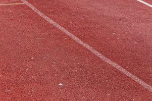 corriendo pista con blanco línea textura, deportes textura para antecedentes foto