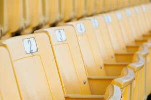 Empty yellow seats at stadium,Rows of seat on a soccer stadium,select focus photo