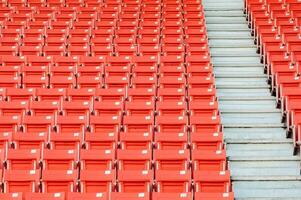 Empty orange seats at stadium,Rows of seat on a soccer stadium photo
