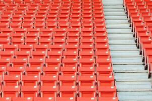 Empty orange seats at stadium,Rows of seat on a soccer stadium photo