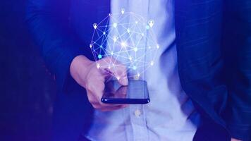 Businessman hand touching global infrastructure network smartphone on virtual screen working with client base online and customer connection data exchange. photo