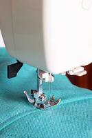 Modern sewing machine and turquoise fabric photo