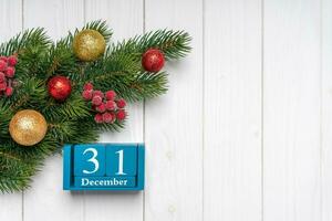 New Year background with decorated fir tree and blue perpetual calendar. Top view, flat lay with copy space photo