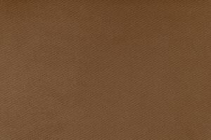 Texture of brown fabric diagonal weave pattern. Decorative textile background photo