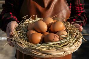 A woman holds a rattan basket with fresh eggs. photo