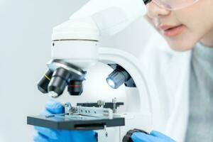 Scientist analyze biochemical samples in advanced scientific laboratory. Medical professional use microscope look microbiological developmental of viral. Biotechnology research in science lab. photo