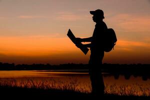 Male tourists standing by the telethon at sunset. photo