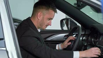 Geschäftsmann Sitzung im ein Neu Auto, Überprüfung aus Innere von ein Fahrzeug video