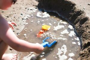 A child plays on the beach. Toys on the beach in the sand photo