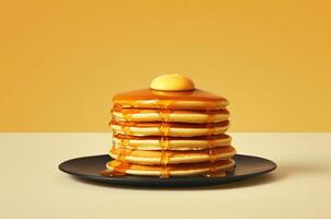 Stack of pancakes with maple syrup and a piece of butter photo