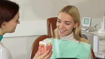 Lovely young woman talking to the dentist at the clinic video