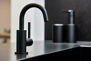 A minimalist bathroom close - up featuring a sleek, matte black faucet with water droplets glistening Generative AI photo