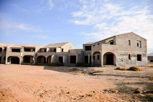 a building in the desert with a lot of rubble photo